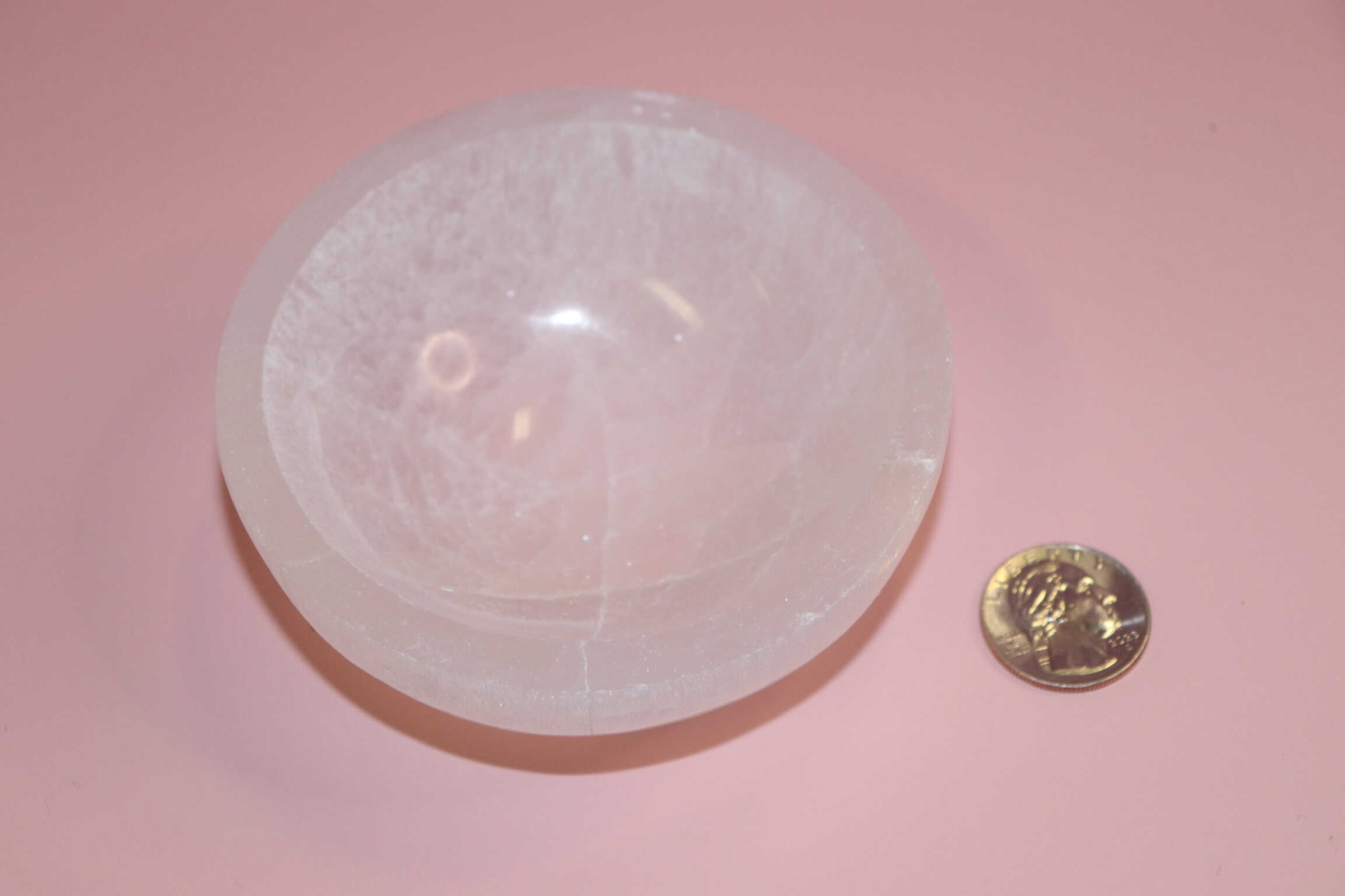 selenite crystal bowl on pink backdrop