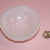selenite crystal bowl on pink backdrop