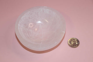 selenite crystal bowl on pink backdrop