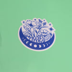 The Flower Moon Phase Sticker on a green background.