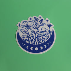 The Flower Moon Phase Sticker on a green background.