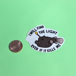 The Anglerfish Vinyl Sticker next to a quarter on a green background.