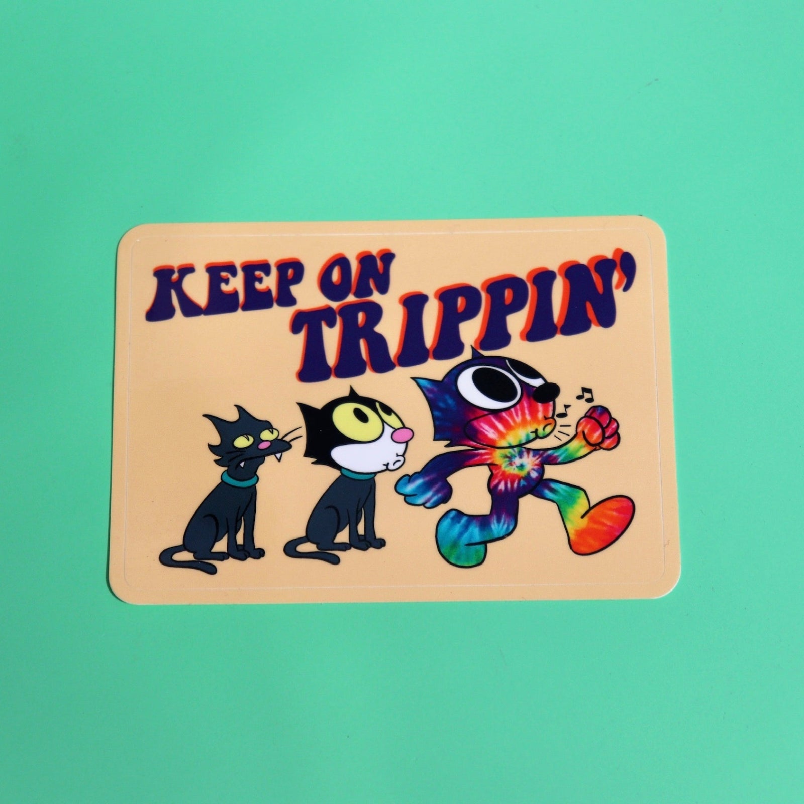 The Keep On Trippin 4 Inch Sticker on a green background.