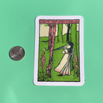 The Lend Me Your Wings O Swallow 3 Inch Sticker next to a quarter on a green background.
