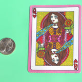 The Queen of Hearts Glitter 3 Inch Sticker next to a quarter on a green background.