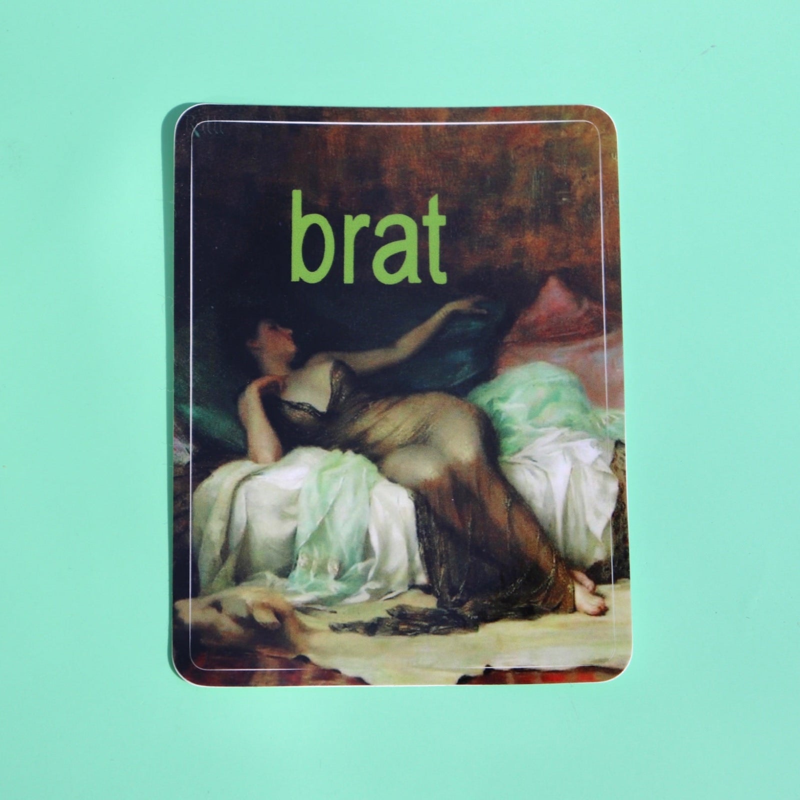 The Brat 3 Inch Vinyl Sticker on a green background.