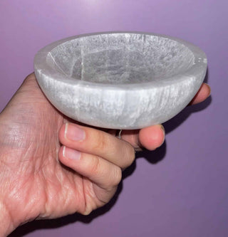 selenite crystal bowl on pink backdrop