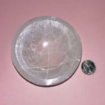selenite crystal bowl on pink backdrop