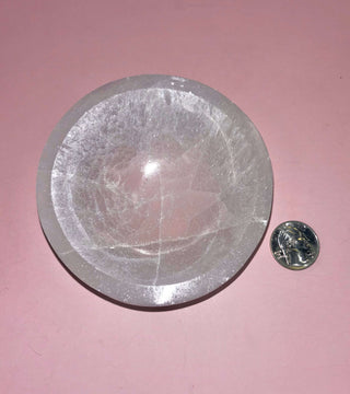 selenite crystal bowl on pink backdrop