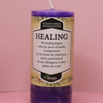 The Affirmation Healing - Pillar Candle with Honeysuckle & Cedar on a pink background.
