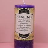 The Affirmation Healing - Pillar Candle with Honeysuckle & Cedar on a pink background.
