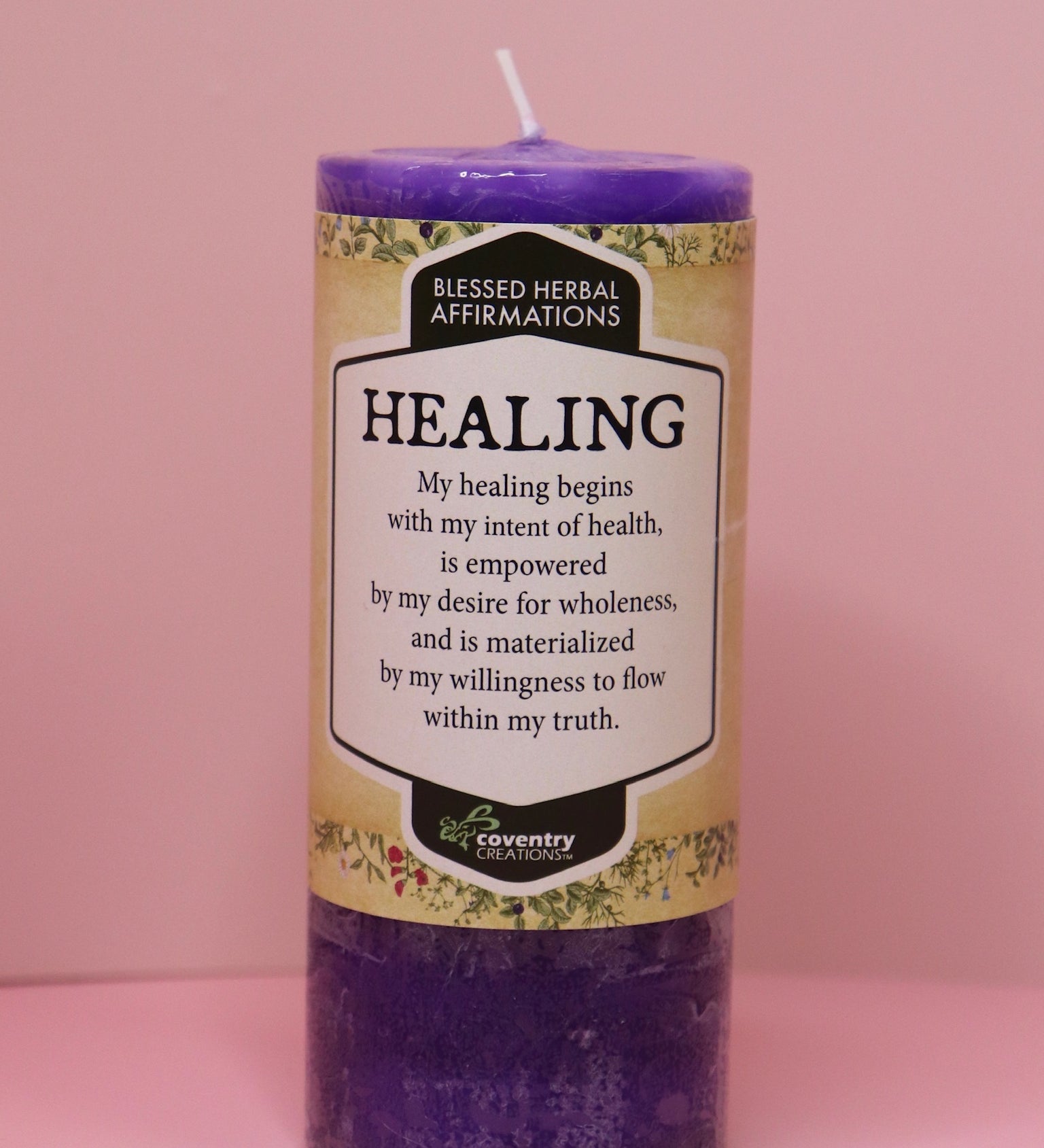 The Affirmation Healing - Pillar Candle with Honeysuckle & Cedar on a pink background.