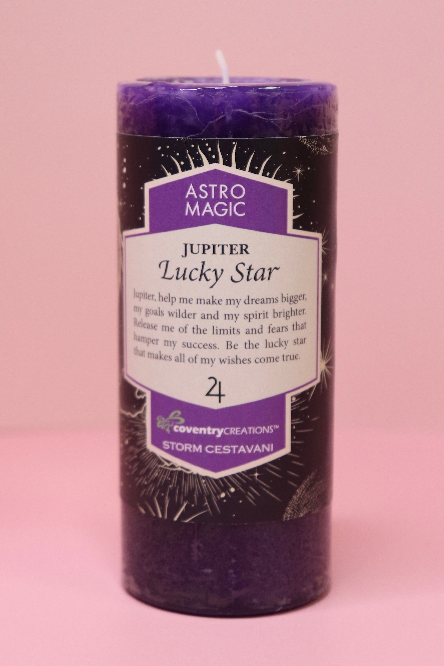 The Astro Magic Jupiter - Lucky Star Pillar Candle on a pink background.