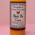 The Wicked Witch Mojo Bitch Be Gone- Scented Pillar Candle on a pink background.
