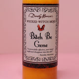 The Wicked Witch Mojo Bitch Be Gone- Scented Pillar Candle on a pink background.