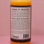 The back of the Wicked Witch Mojo Bitch Be Gone- Scented Pillar Candle on a pink background.