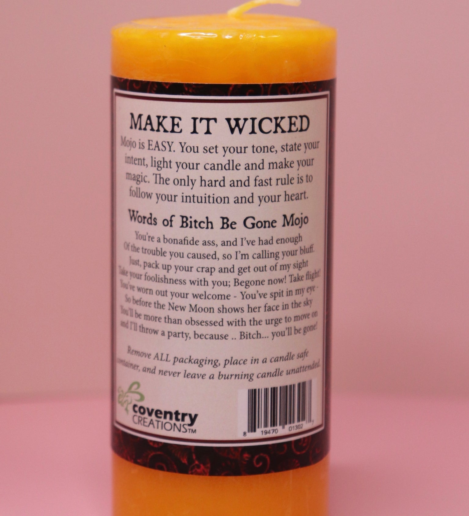 The back of the Wicked Witch Mojo Bitch Be Gone- Scented Pillar Candle on a pink background.
