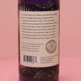 The back of the Astro Magic Jupiter - Lucky Star Pillar Candle on a pink background.