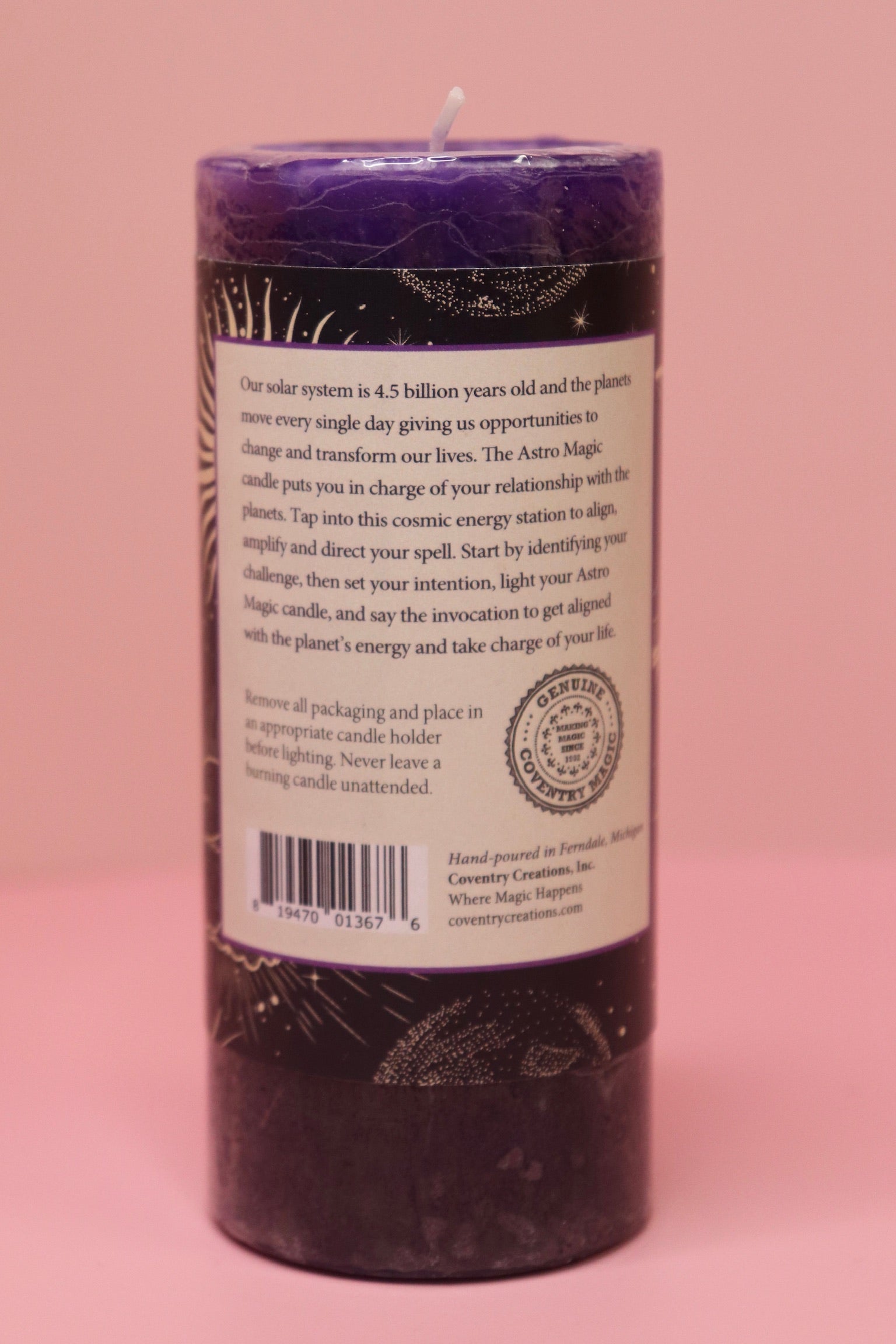 The back of the Astro Magic Jupiter - Lucky Star Pillar Candle on a pink background.