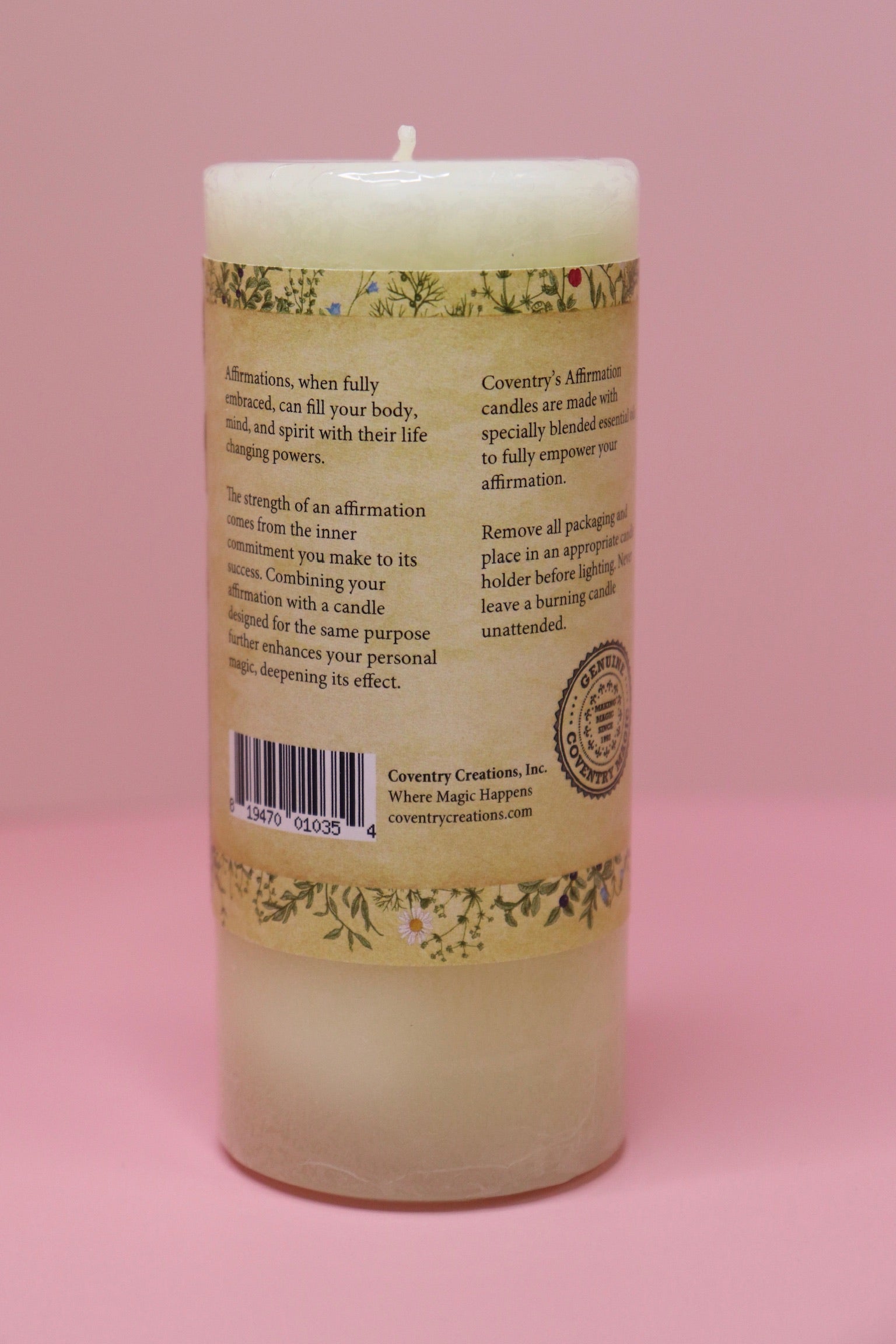 The back of the Affirmation Grief Candle - Pillar Candle with Cypress Blend on a pink background.