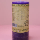The back of the Affirmation Healing - Pillar Candle with Honeysuckle & Cedar on a pink background.
