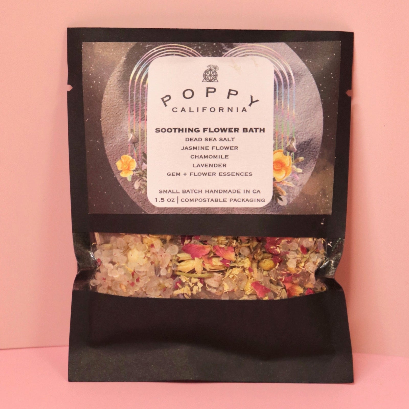 The Soothing Flower Bath Salt Packet on a pink background.
