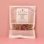 The Loving Flower Bath Salt Packet on a pink background.