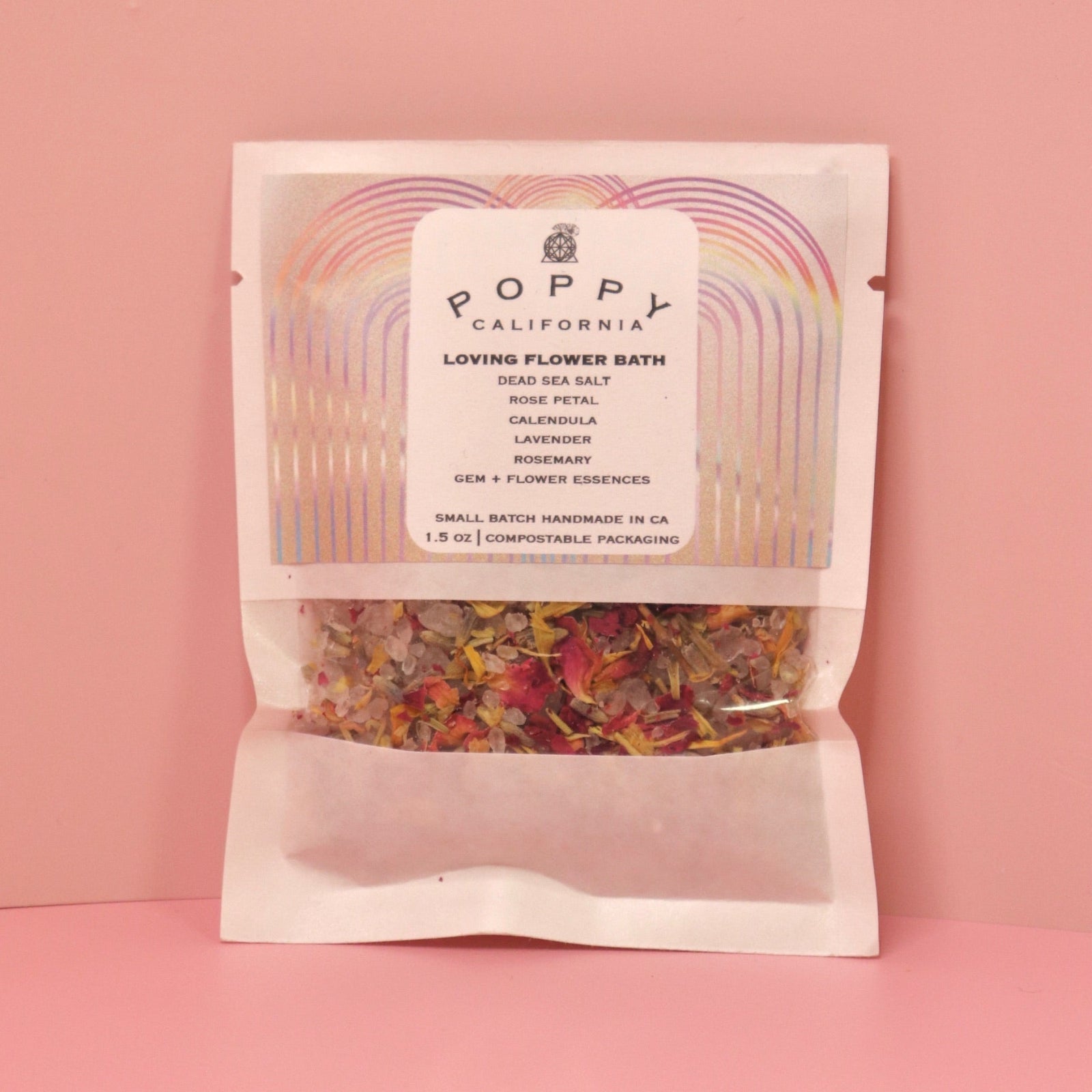 The Loving Flower Bath Salt Packet on a pink background.