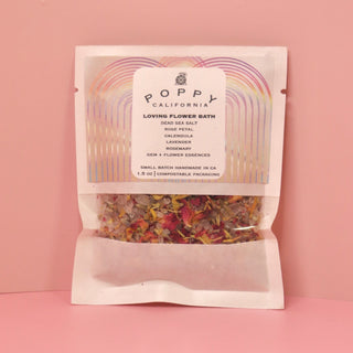 The Loving Flower Bath Salt Packet on a pink background.