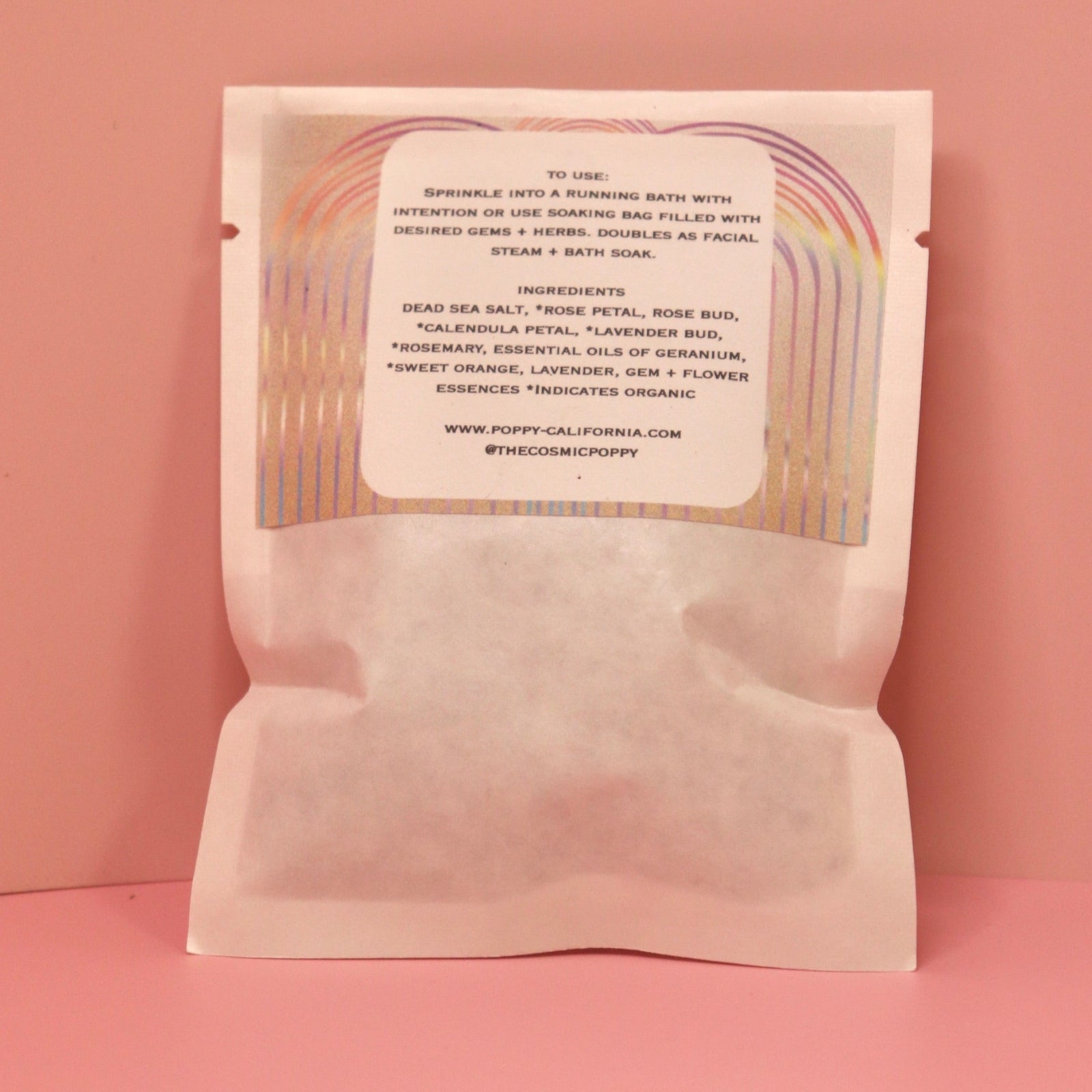 The back of the Loving Flower Bath Salt Packet on a pink background.