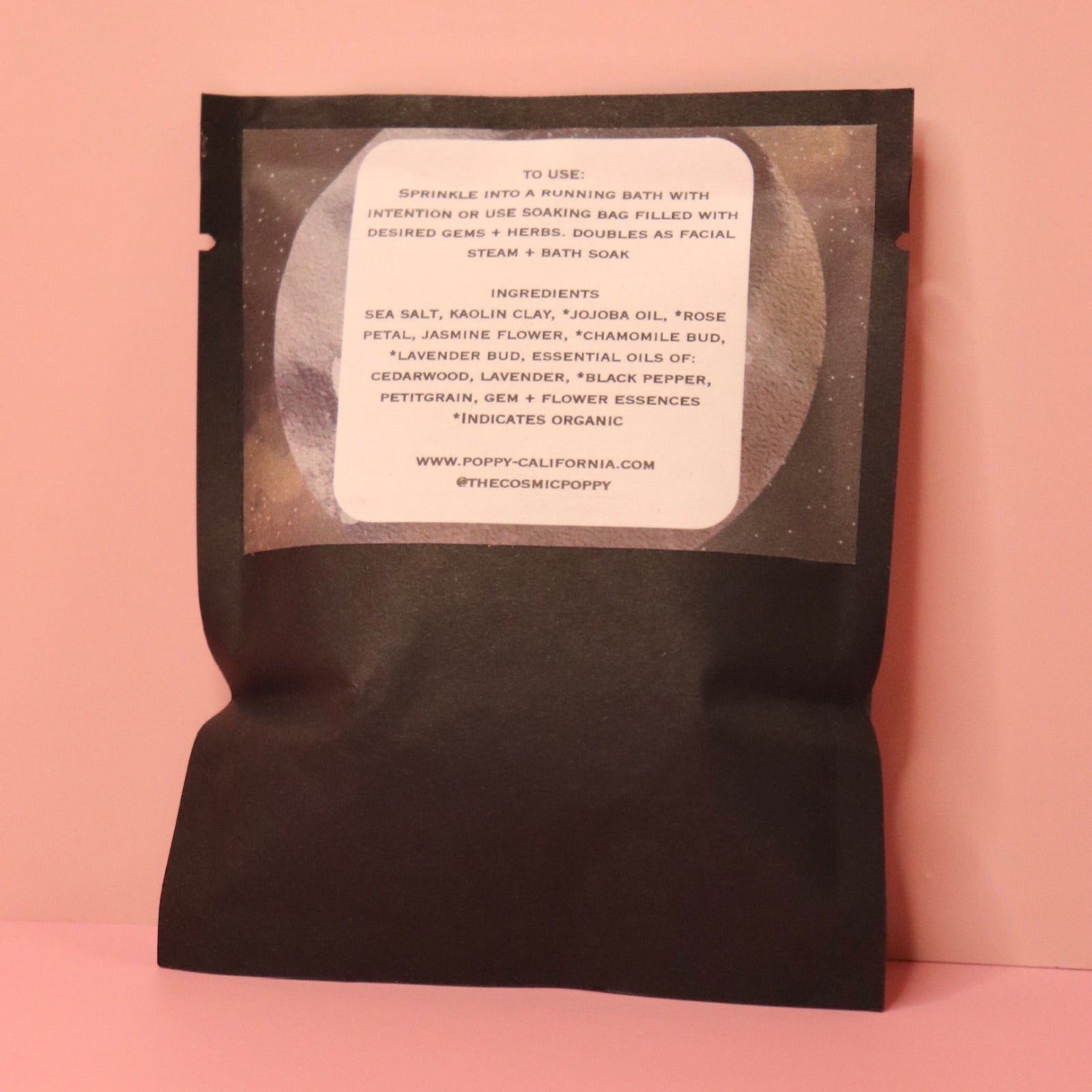 The back of the Soothing Flower Bath Salt Packet on a pink background.