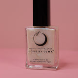 The Full Moon Nail Polish on a pink background.