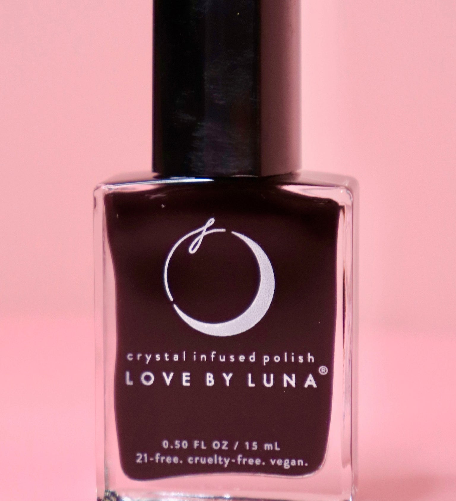 The Capricorn Zodiac Nail Polish with Micronized Garnet on a pink background.