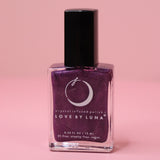 The Luminous Dreams Nail Polish with Micronized Amethyst on a pink background.