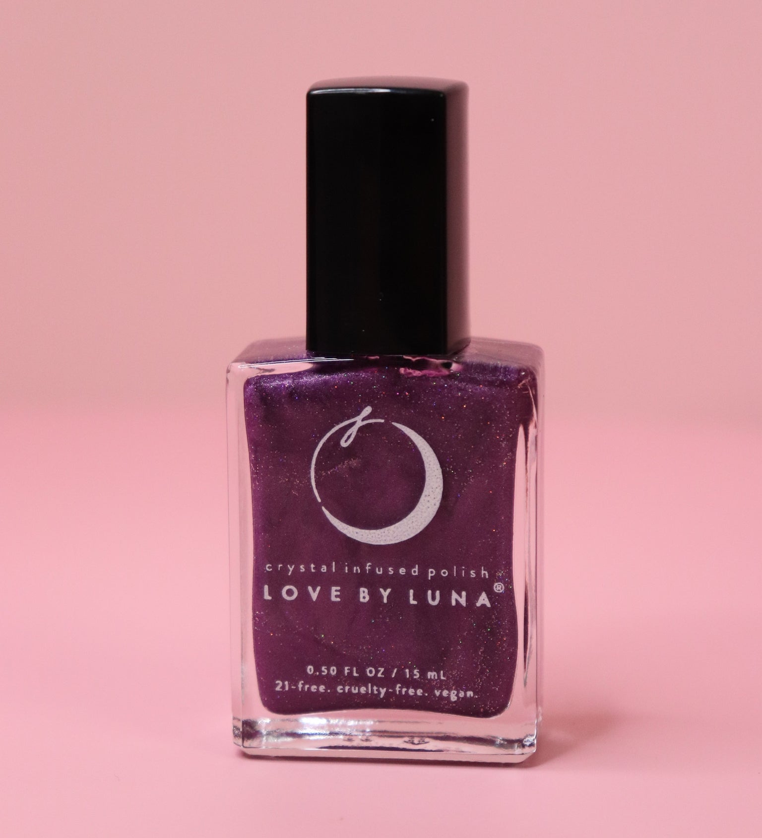 The Luminous Dreams Nail Polish with Micronized Amethyst on a pink background.