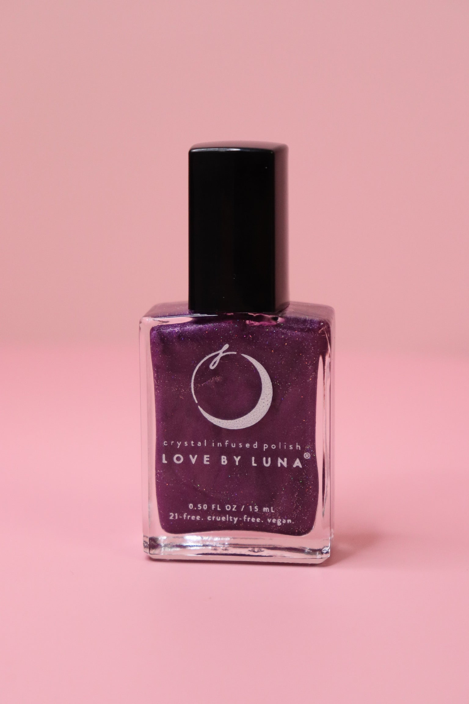 The Luminous Dreams Nail Polish with Micronized Amethyst on a pink background.