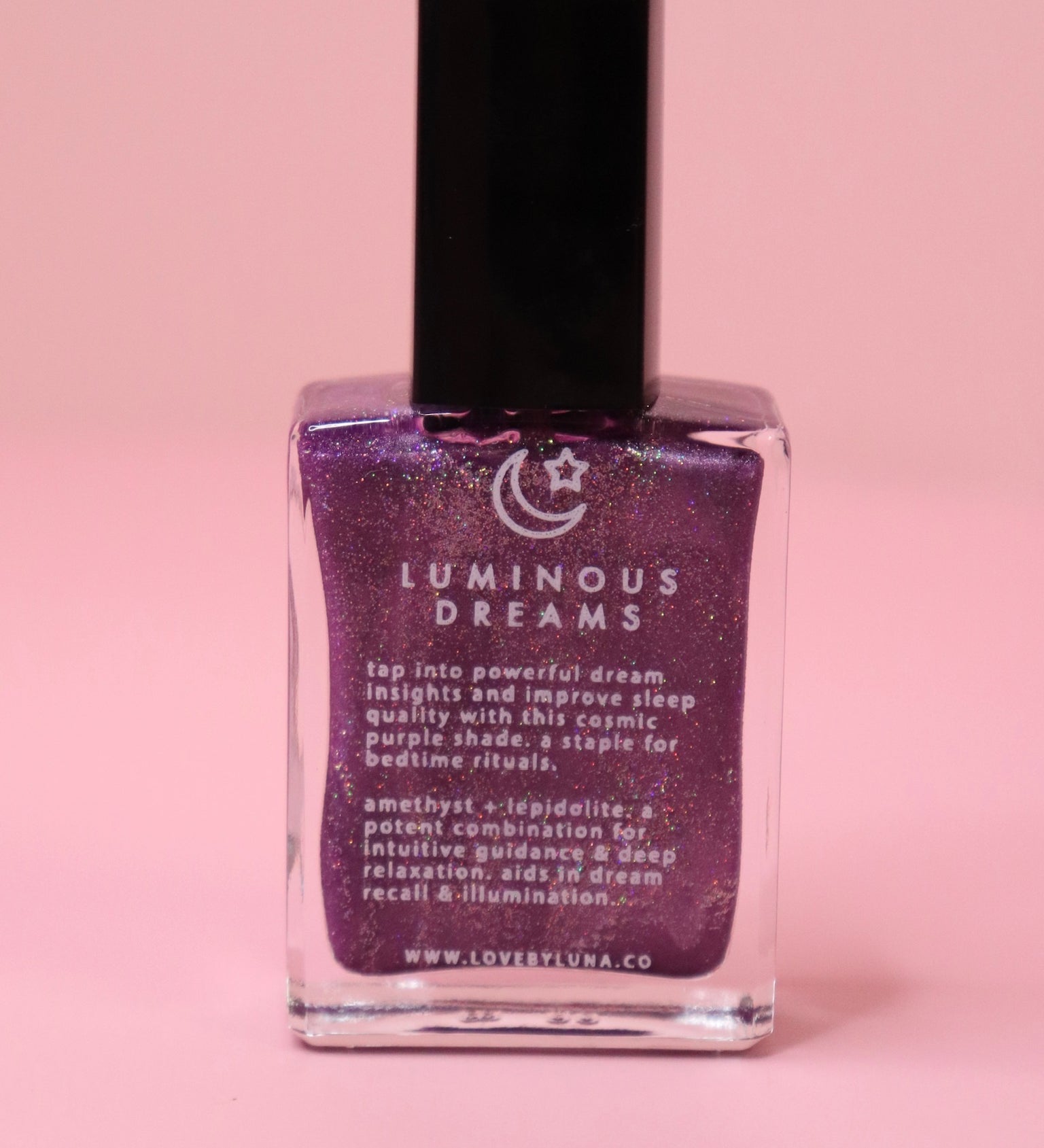 The Luminous Dreams Nail Polish with Micronized Amethyst on a pink background.
