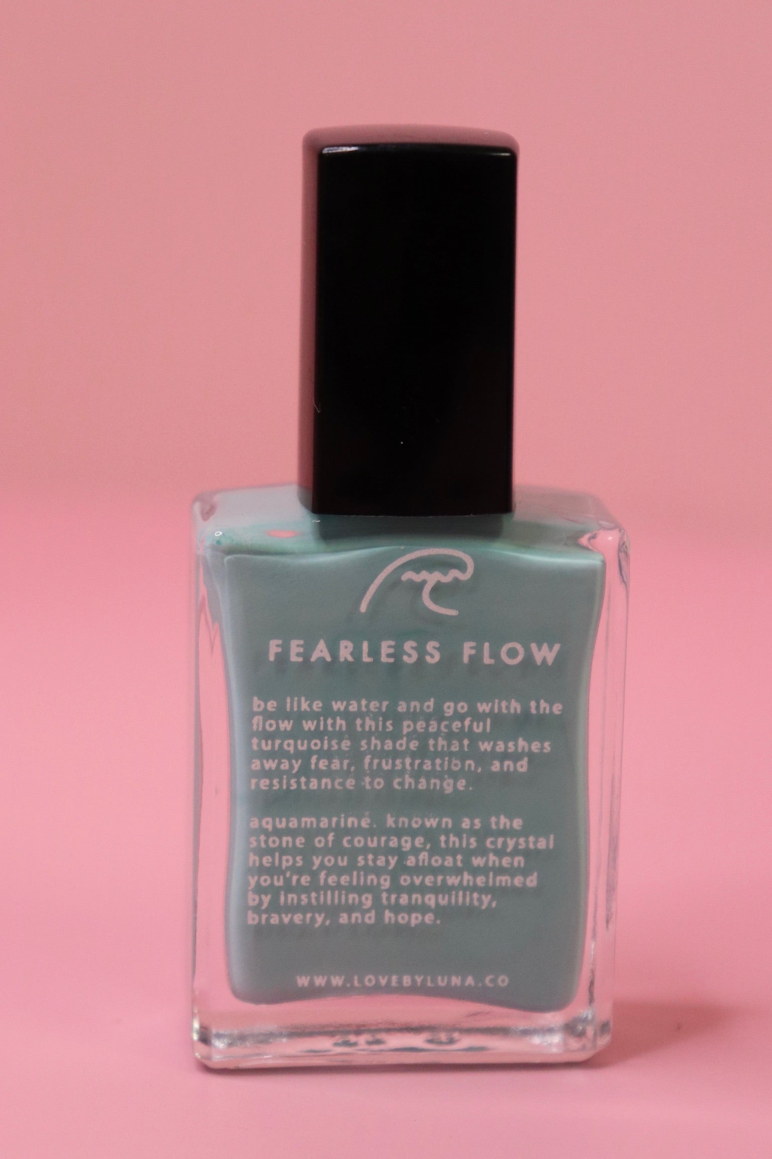The Fearless Flow Nail Polish with Micronized Aquamarine on a pink background.