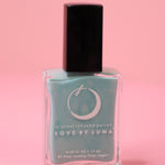 The Fearless Flow Nail Polish with Micronized Aquamarine on a pink background.