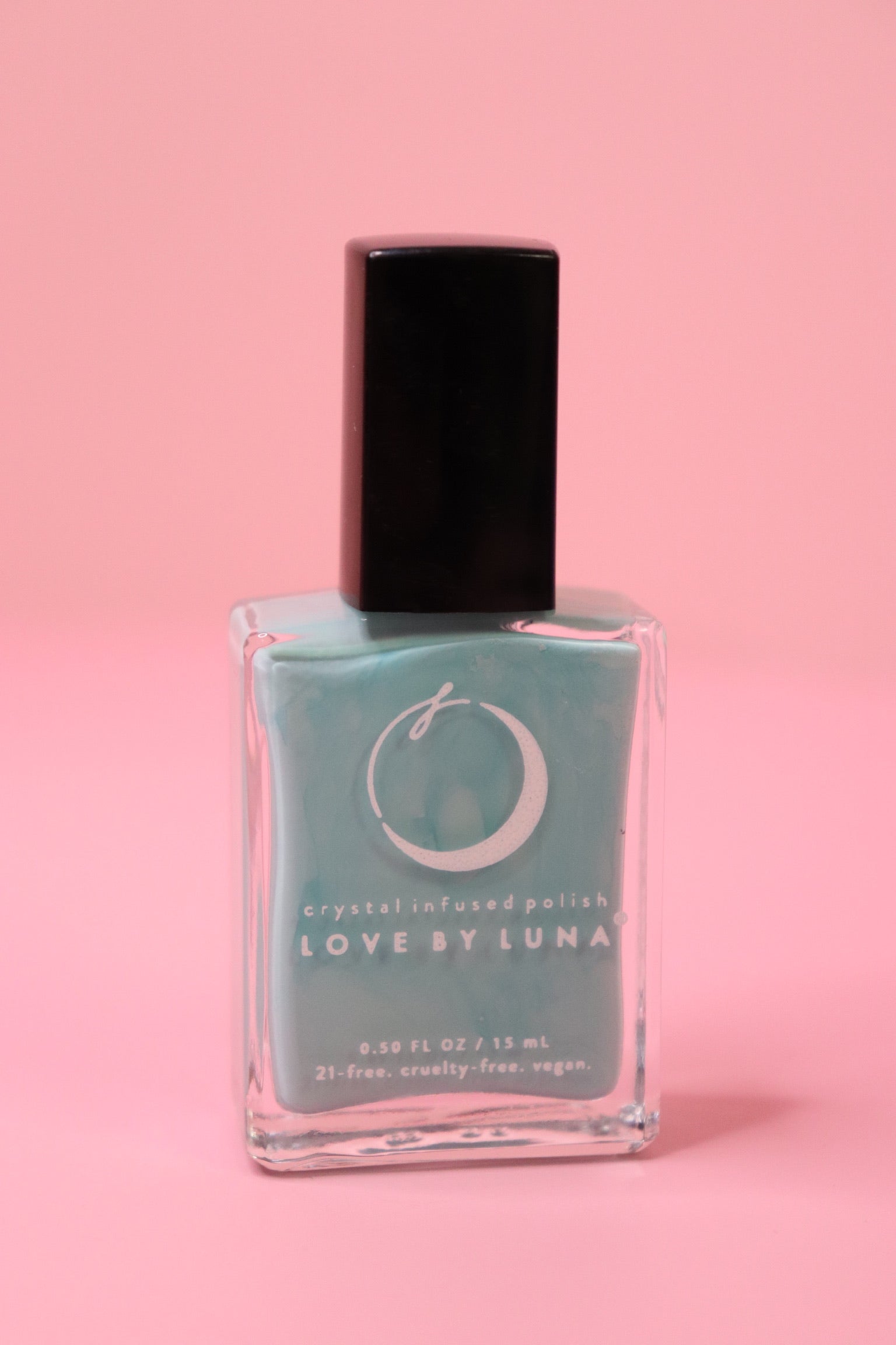 The Fearless Flow Nail Polish with Micronized Aquamarine on a pink background.