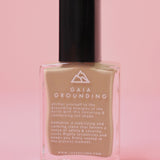The Gaia Grounding Nail Polish with Micronized Hematite on a pink background.