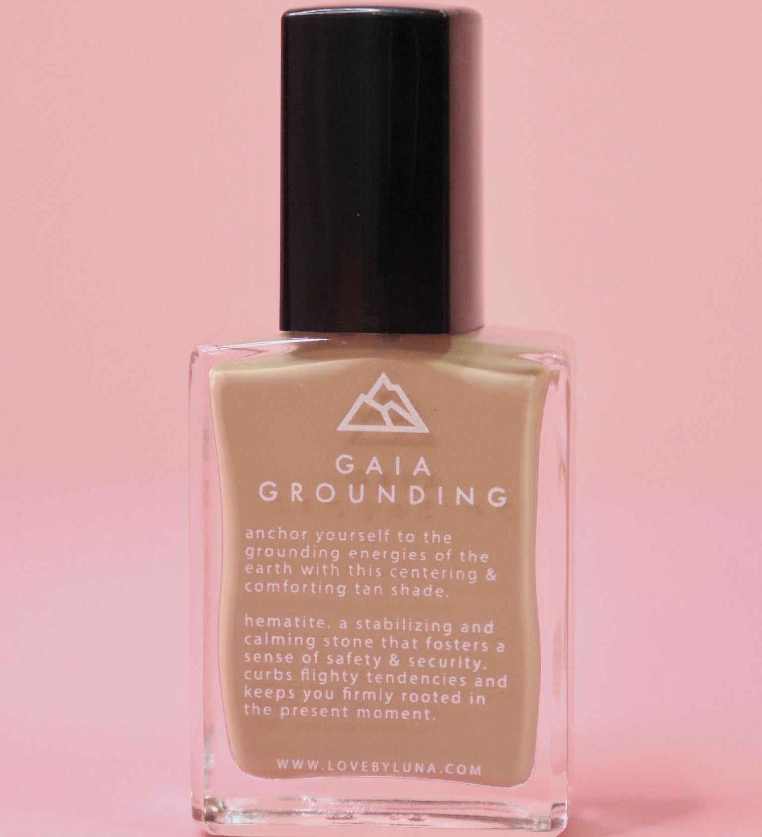The Gaia Grounding Nail Polish with Micronized Hematite on a pink background.