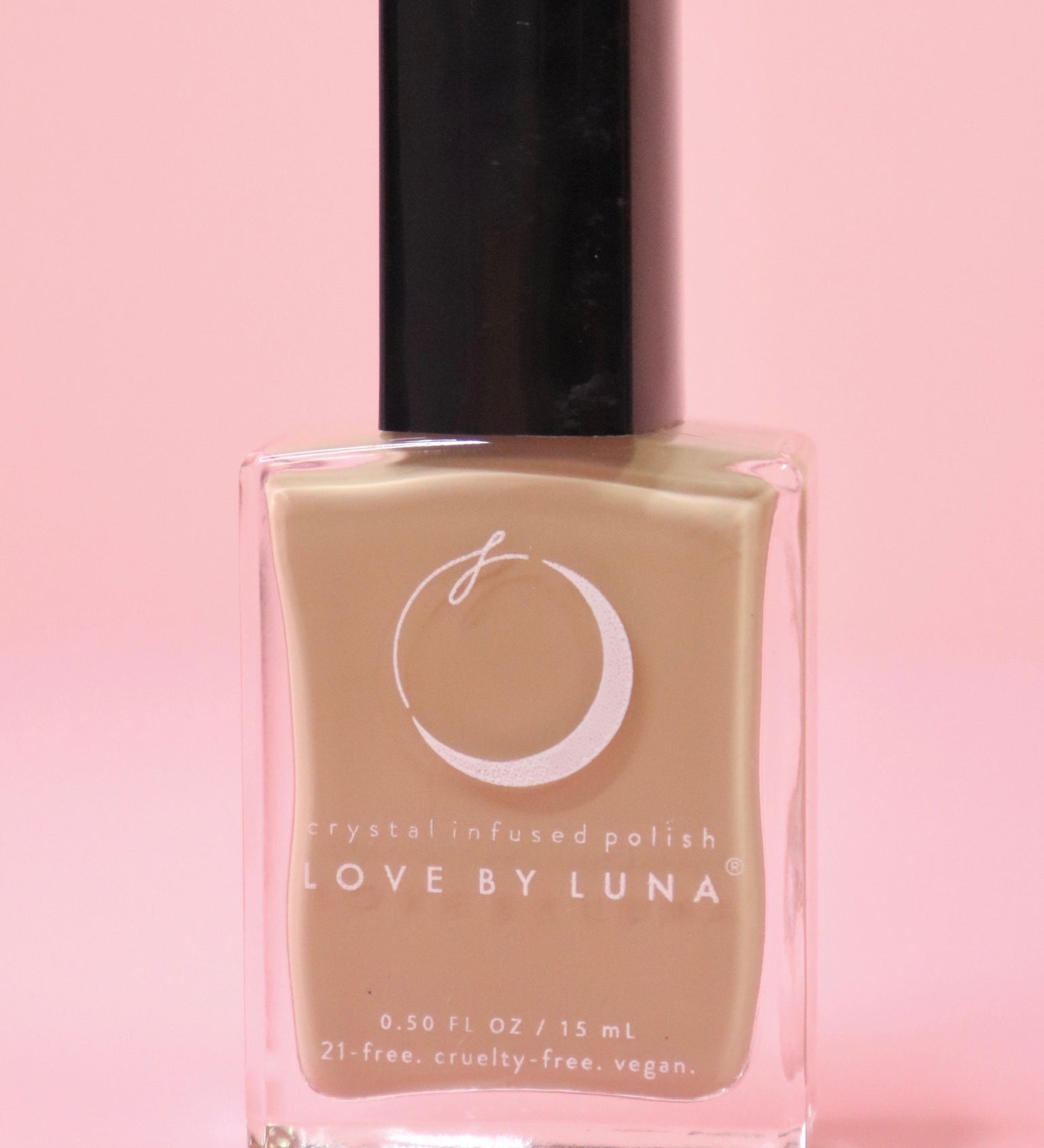 The Gaia Grounding Nail Polish with Micronized Hematite on a pink background.