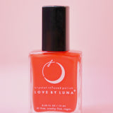 The Aries Zodiac Nail Polish with Micronized Red Jasper on a pink background.