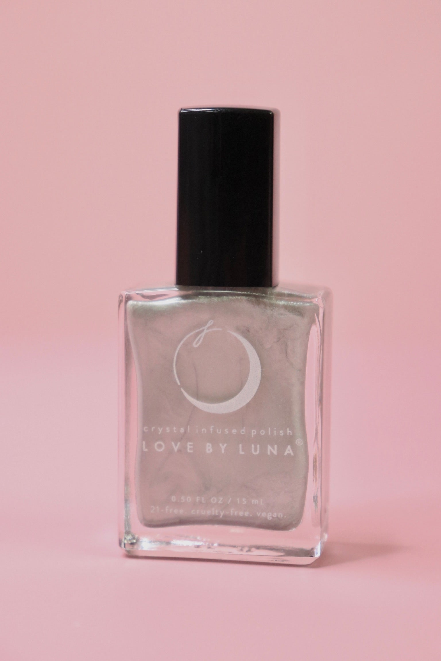 The Aquarius Zodiac Nail Polish with Micronized Amethyst on a pink background.