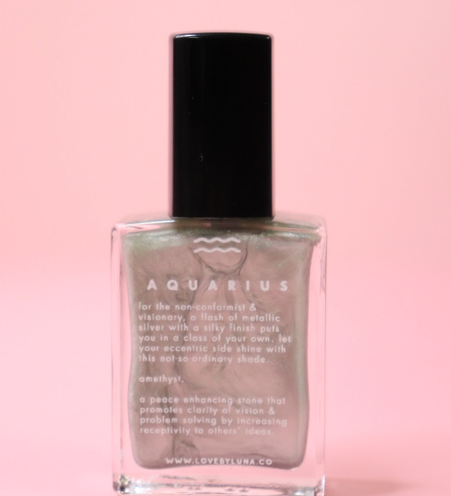 The Aquarius Zodiac Nail Polish with Micronized Amethyst on a pink background.