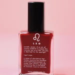 The Leo Zodiac Nail Polish with Micronized Tiger's Eye on a pink background.