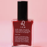 The Leo Zodiac Nail Polish with Micronized Tiger's Eye on a pink background.