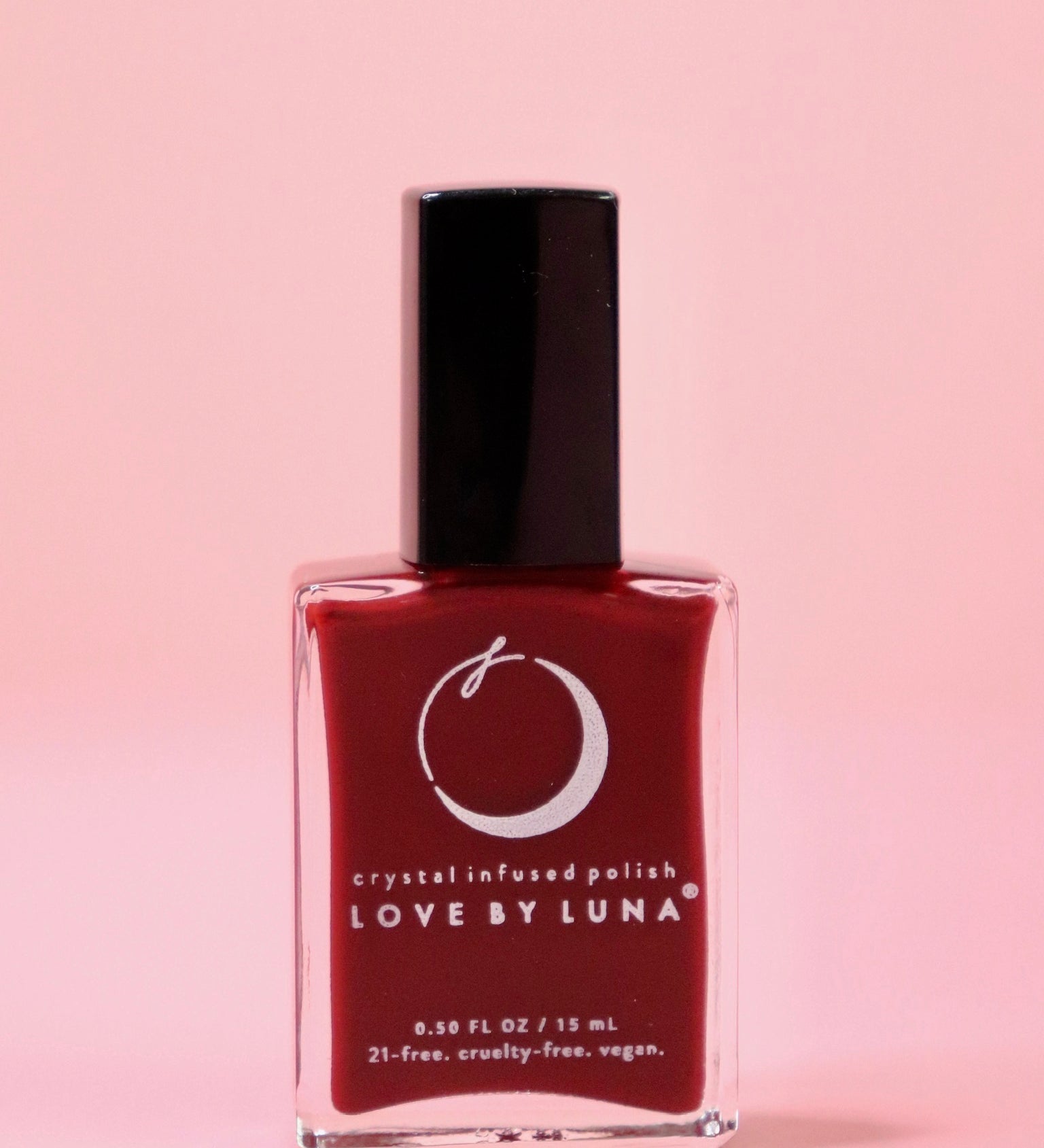 The Leo Zodiac Nail Polish with Micronized Tiger's Eye on a pink background.