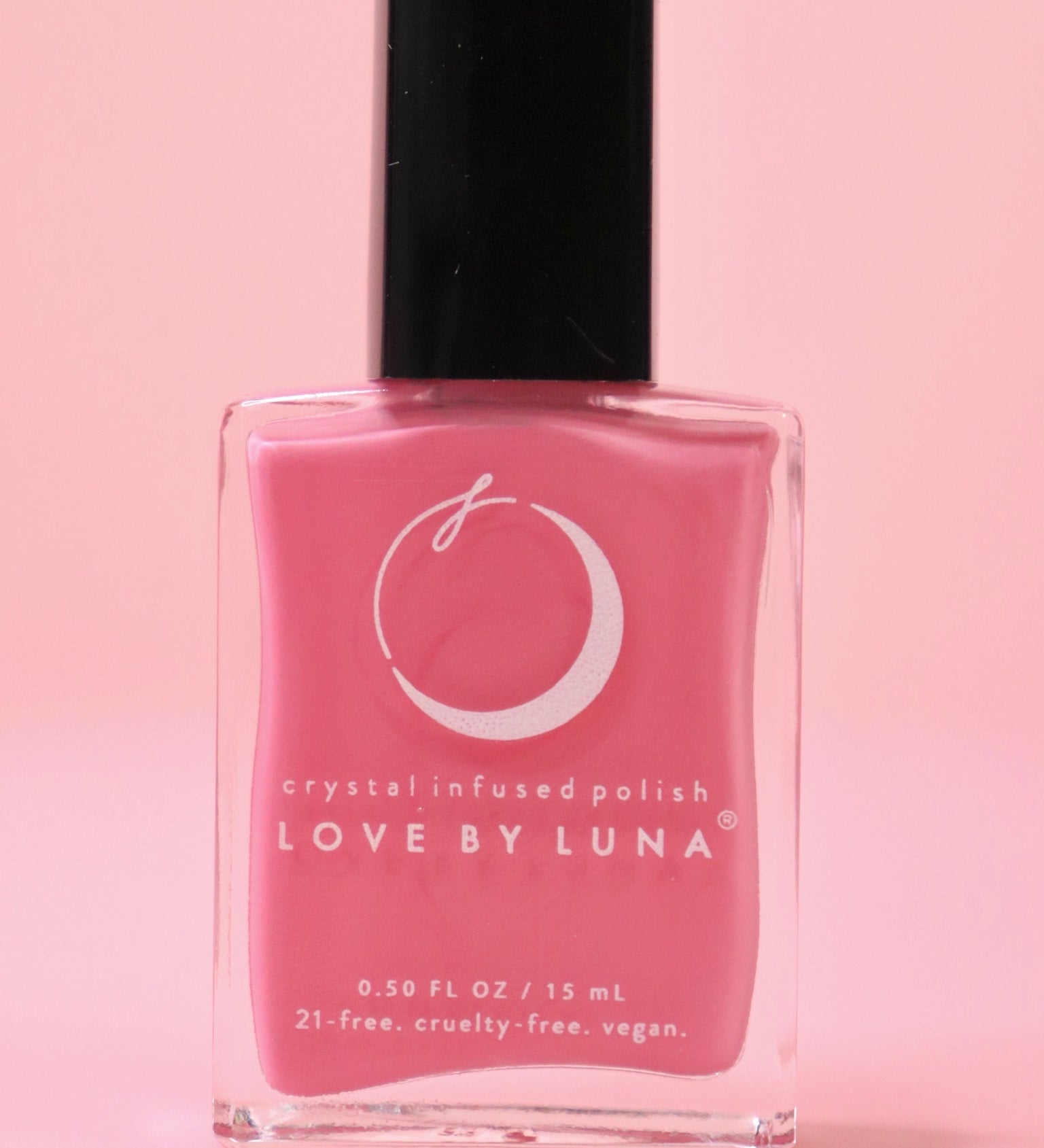 The Love in Bloom Nail Polish with Micronized Rose Quartz & Pink Calcite on a pink background.
